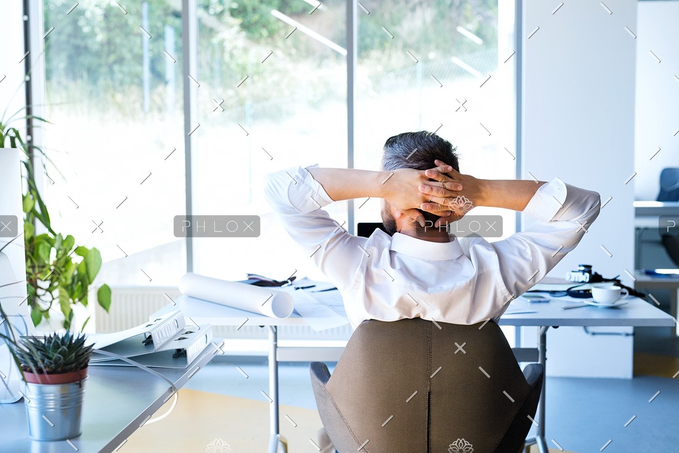 Businessman-at-the-desk-in-his-office-resting.-1